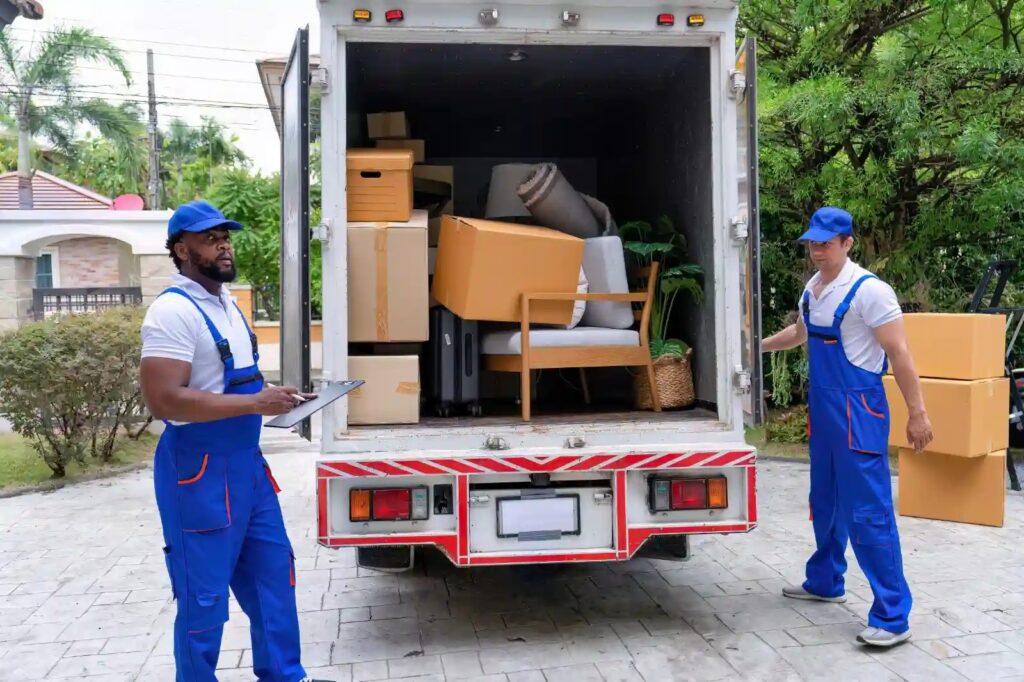 Movers carefully packing and loading belongings into a well-maintained moving truck.