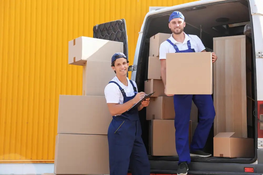 Professional movers handling heavy boxes with care during the relocation